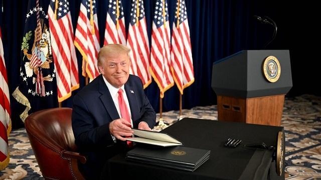 Trump smiles signs executive orders